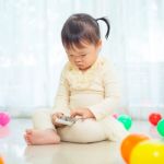 Little Girl Using Mobile Phone Stock Photo