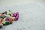 Heap Of Medicine Pills On Cardiogram Grid Paper. Selective Focus Stock Photo