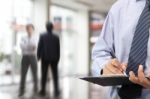 Businessman Signing A Document Stock Photo