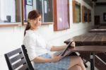 Portrait Of Thai Adult Businesswoman Beautiful Girl Using Her Tablet Stock Photo