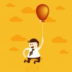 Business Man Flying With Balloon Stock Photo