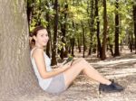 Girl In Park With Tablet Computer Stock Photo