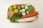 Fresh Vegetables In The Rattan Basket On Wood Background Stock Photo