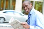 Handsome Businessman Reading A Newspaper Stock Photo