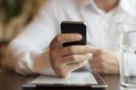 Man With Smartphone And Tablet Computer In Restaurant Stock Photo