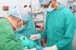 Student Assistant Helping Doctor In A Surgery Stock Photo