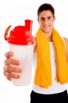 Front View Of Young Man Offering Drink Stock Photo