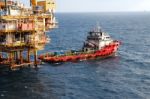  Supply Boat Transfer Cargo To Oil And Gas Industry And Moving Cargo From The Boat To The Platform Stock Photo