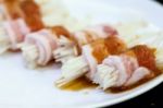 Raw Bacon Wrapped With Needle Mushroom Stock Photo