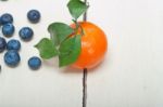 Tangerine And Blueberry On White Table Stock Photo