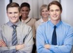 Cheerful Work Team Posing, Arms Crossed Stock Photo