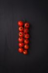 Organic Fresh Cherry Tomatoes On Black Board Background Stock Photo