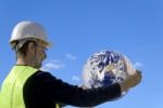 Technician Holding The Earth Stock Photo