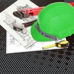 Green Hard Hat On Blueprint Stock Photo