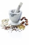 Marble Mortar And Pestle With Assorted Spices On White Backgroun Stock Photo