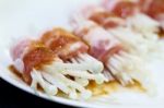 Raw Bacon Wrapped With Needle Mushroom Stock Photo