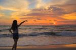 Woman Silhouette In The Sunset And Pointing Stock Photo