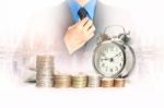 Double Exposure Of Businessman With A Row Of Stack Money Coins Stock Photo