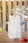 Drinking Water Is Poured Into Iced Glass Stock Photo