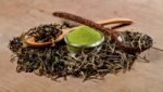 Dried Tea Leaf And Powder With Spoon On Wood Stock Photo