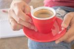 Woman In Torn Jeans Sitting At Coffee Shop Stock Photo