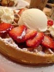 Waffle With Strawberries, Powdered Sugar And Ice Cream Stock Photo