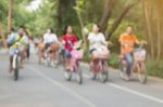 Blurred Image Of People Riding Bicycle In Park Stock Photo