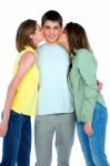 Teenage Girls Kissing Boy Stock Photo