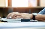 Attractive  Man In Casual Business Sitting At A Table Working On Stock Photo