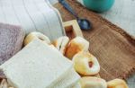 Breads And Cup On Wooden Floor Stock Photo