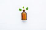 Mint Essential Oil In A Glass Bottle With Leaves On White Backgr Stock Photo