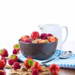 Bran Flakes With Fresh Raspberries And Strawberries And Pitcher Stock Photo