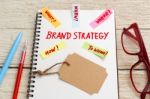 Brand Marketing Strategy Concept With Brand Tag On Notebook Stock Photo