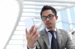 Asia Business Man Using A Mobile Phone Stock Photo