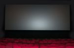 Empty Seat On Row In Thearter With Movie Screen Stock Photo