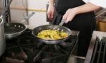 Chef Cooking Rigatoni With Vegetables In A Pan Stock Photo