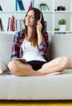 Beautiful Young Woman Listening To Music At Home Stock Photo