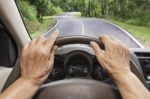 Senior Woman Driving A Car On Highway Stock Photo