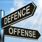 Defence Offense Signpost Shows Defending And Tactics Stock Photo