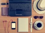 Office Desk With Computer, Supplies, Coffee Cup, Passport, Hat, Stock Photo