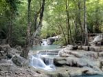 Waterfall Flowing Into The Water Is Blue Stock Photo