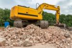 Yellow Belt Excavator On Heap Of Bricks Stock Photo