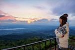 Woman Tourist Watching The Sunrise Stock Photo