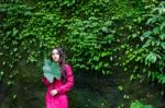 Summer Portrait Of Young  Women Enjoying Nature  In Tight Fitting Red Dress Summer Vacation,sunny,having Fun, Positive Mood,romantic, Against Background Of Summer Green Park, Green Leaves Stay Outdoor Stock Photo