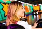 Beautiful Girl In An Electric Bumper Car At Amusement Park Stock Photo