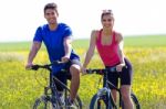 Happy Young  Couple On A Bike Ride In The Countryside Stock Photo