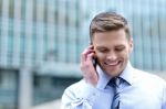 Smiling Corporate Guy Talking On The Phone Stock Photo