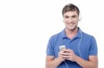 Young Man Enjoying Music From His Cell Phone Stock Photo