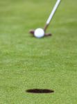 Hitting Golf Ball Into Hole Stock Photo