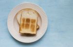 White Toast On Blue Table Background Stock Photo